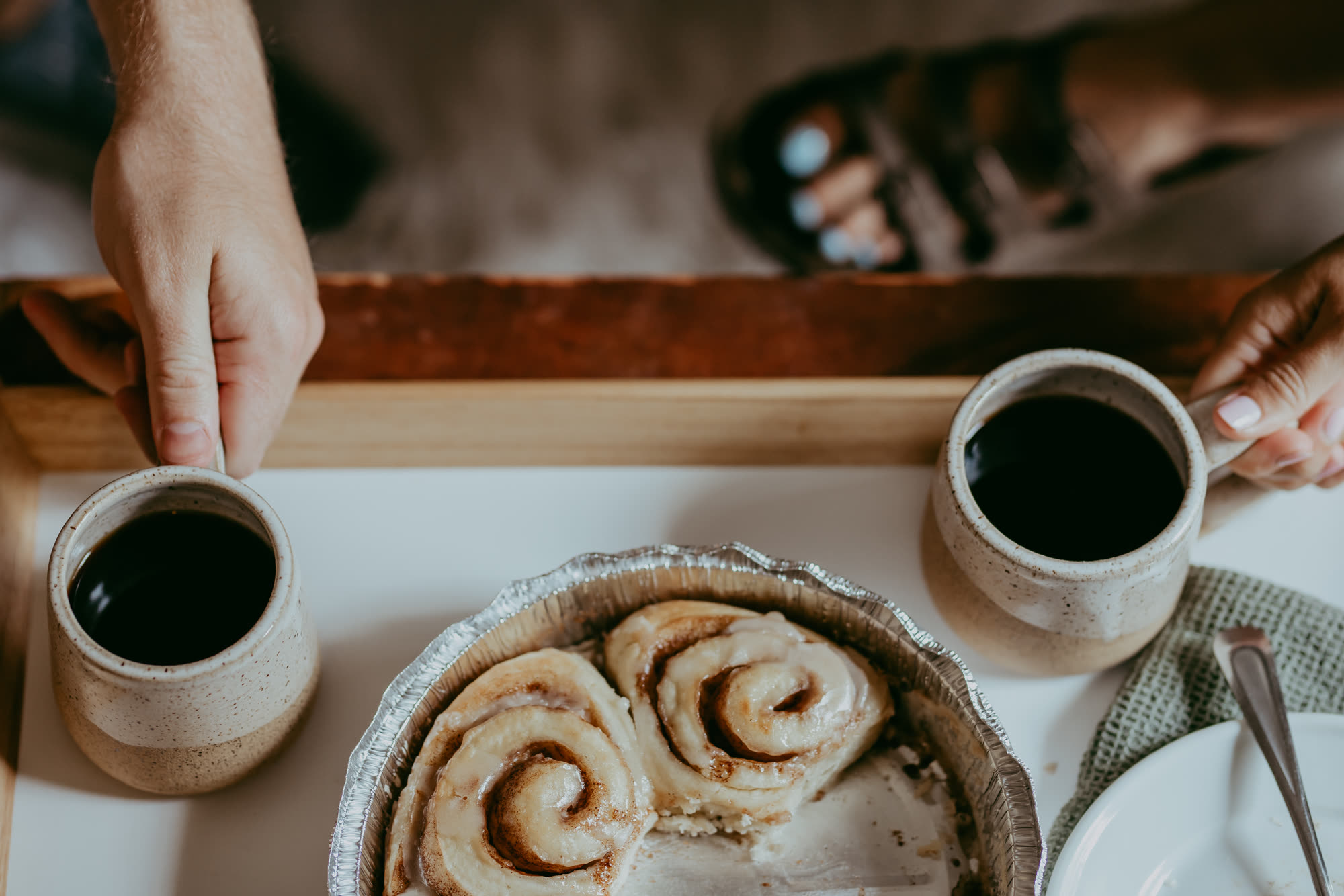 Coffee and a pan of cinnamon rolls shared at the table