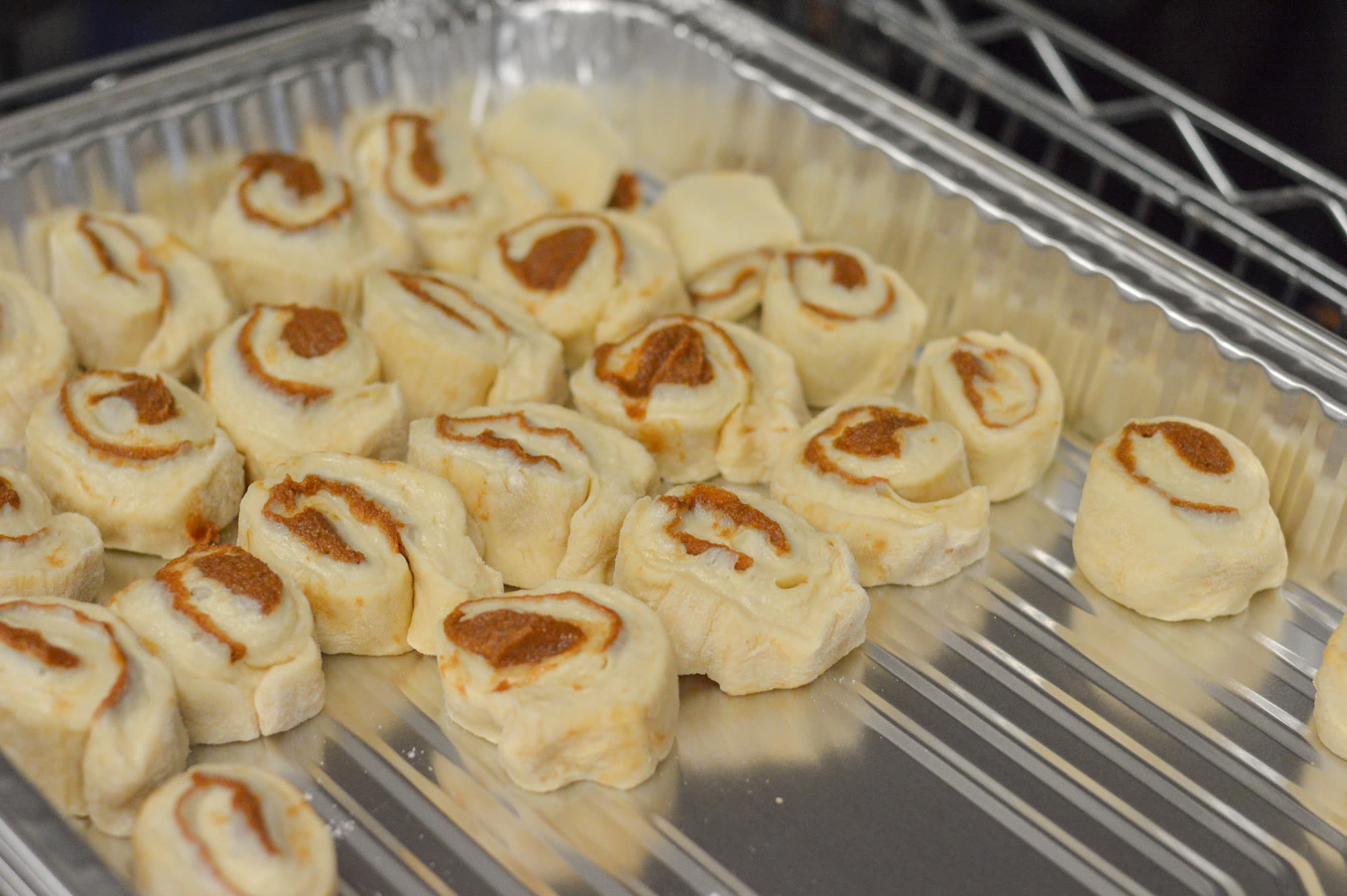 Trays of freshly baked cinnamon rolls