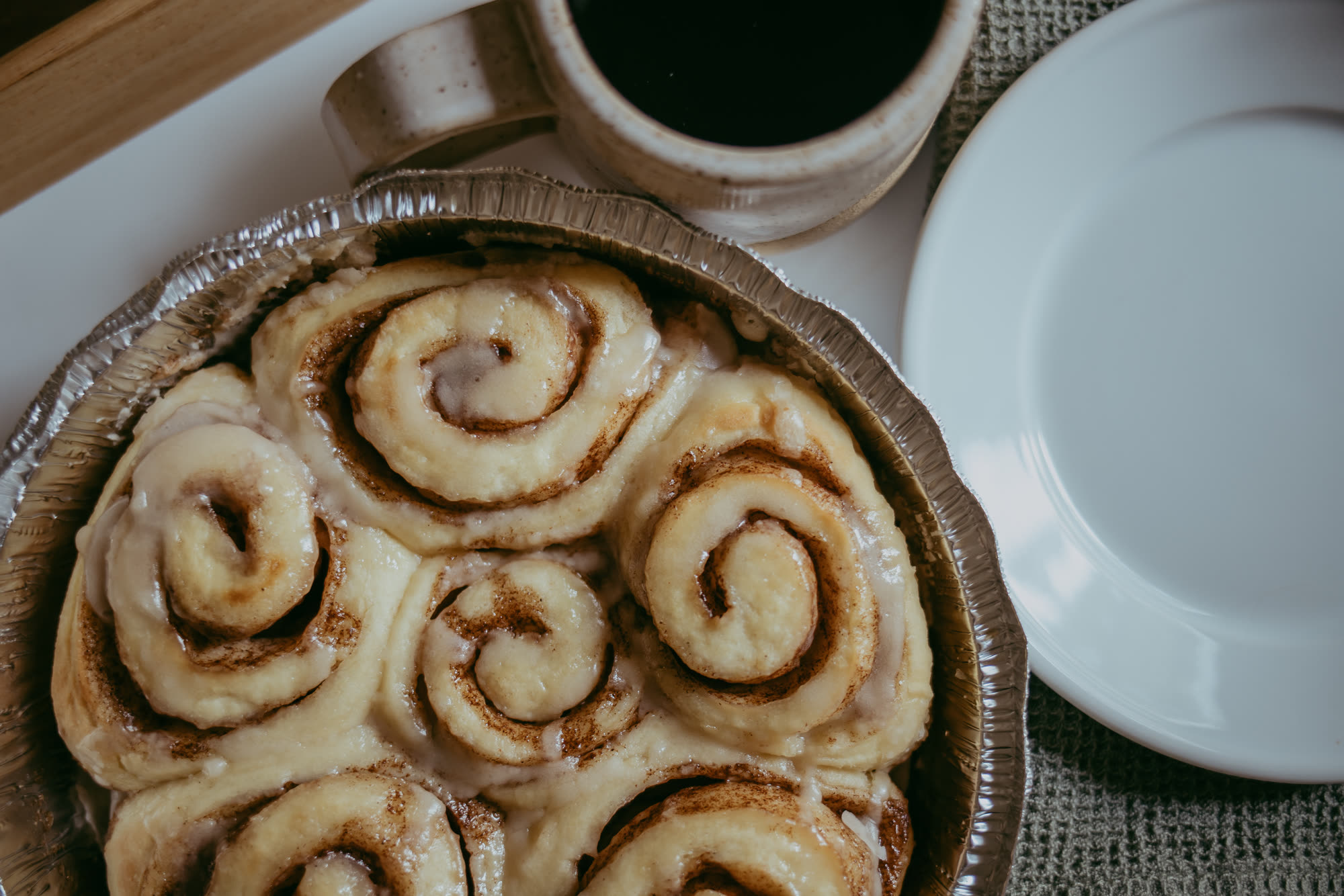 A pan of warm hand-rolled cinnamon rolls with maple coffee glaze in Richmond, VA